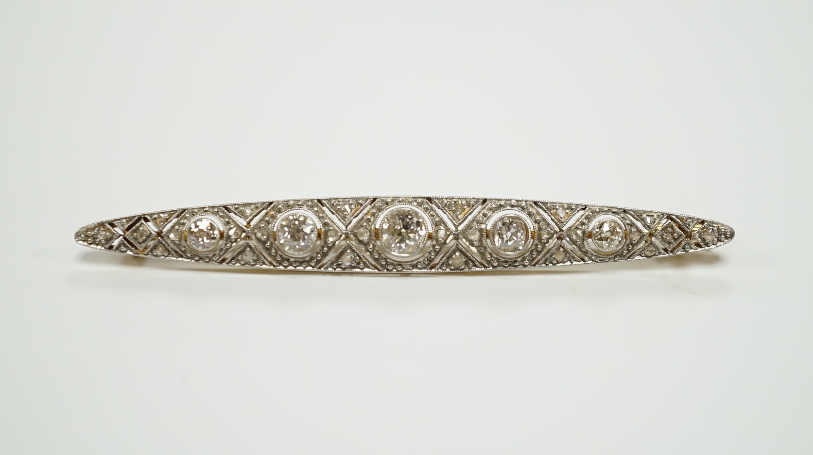 A Belle Epoque yellow and white metal mounted diamond cluster set navette shaped bar brooch, 69mm, gross weight 6.5 grams.